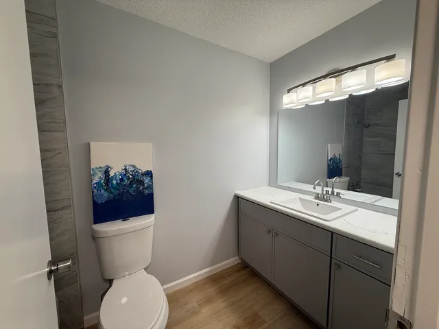 a bathroom with a toilet sink and mirror