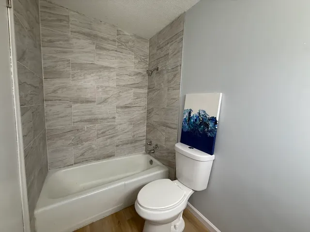 a bathroom with a toilet and a shower