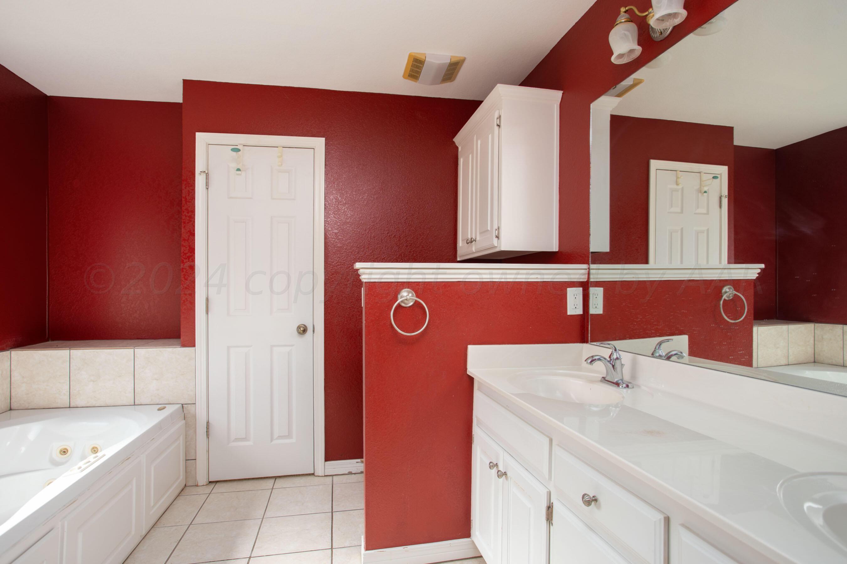6501 Academy Drive Amarillo, TX 79119 - Photo 13 of 22 a bathroom with a sink a bath tub and a shower