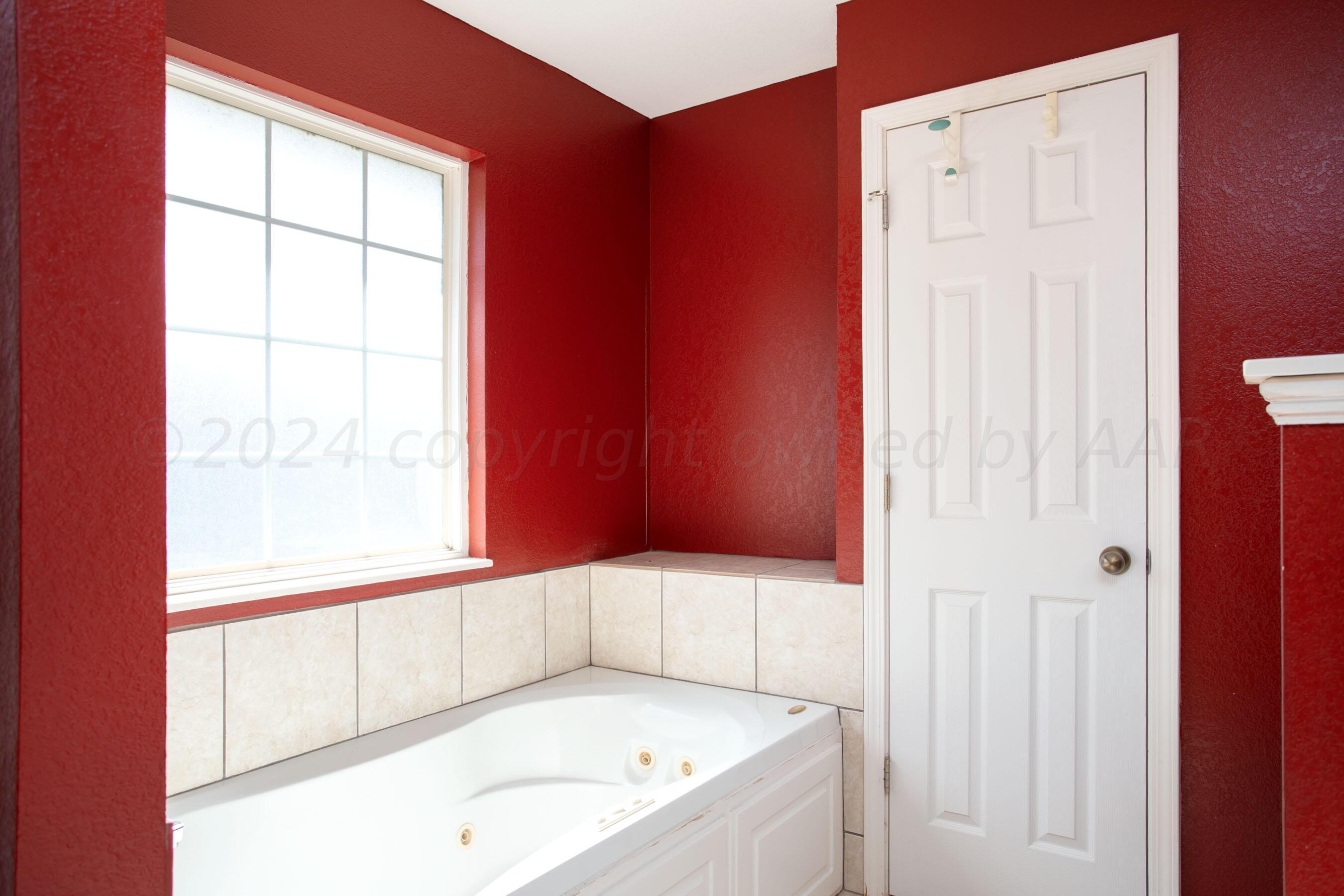6501 Academy Drive Amarillo, TX 79119 - Photo 15 of 22 a bathroom with a tub and a shower