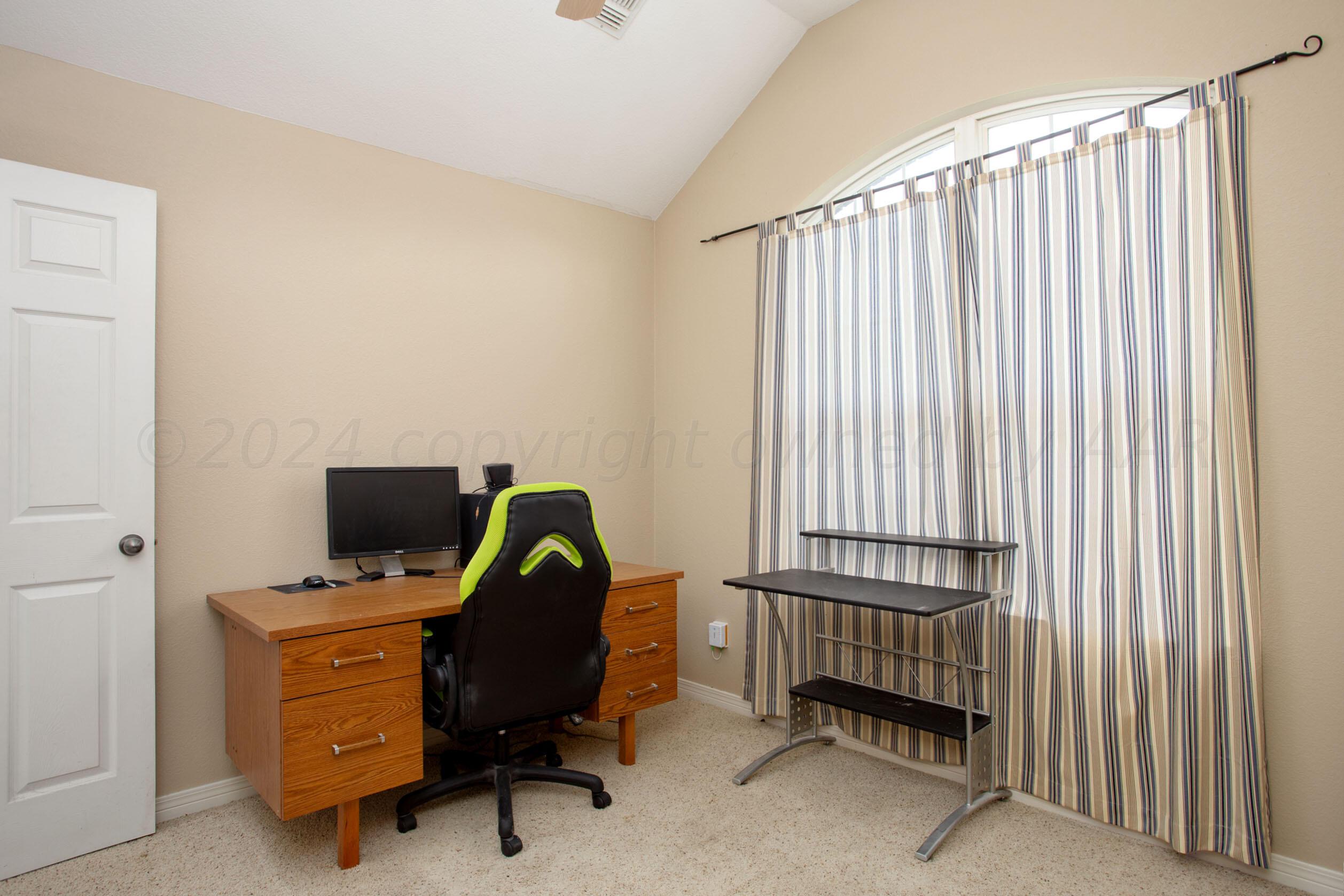 6501 Academy Drive Amarillo, TX 79119 - Photo 20 of 22 a view of a workspace with furniture and a window