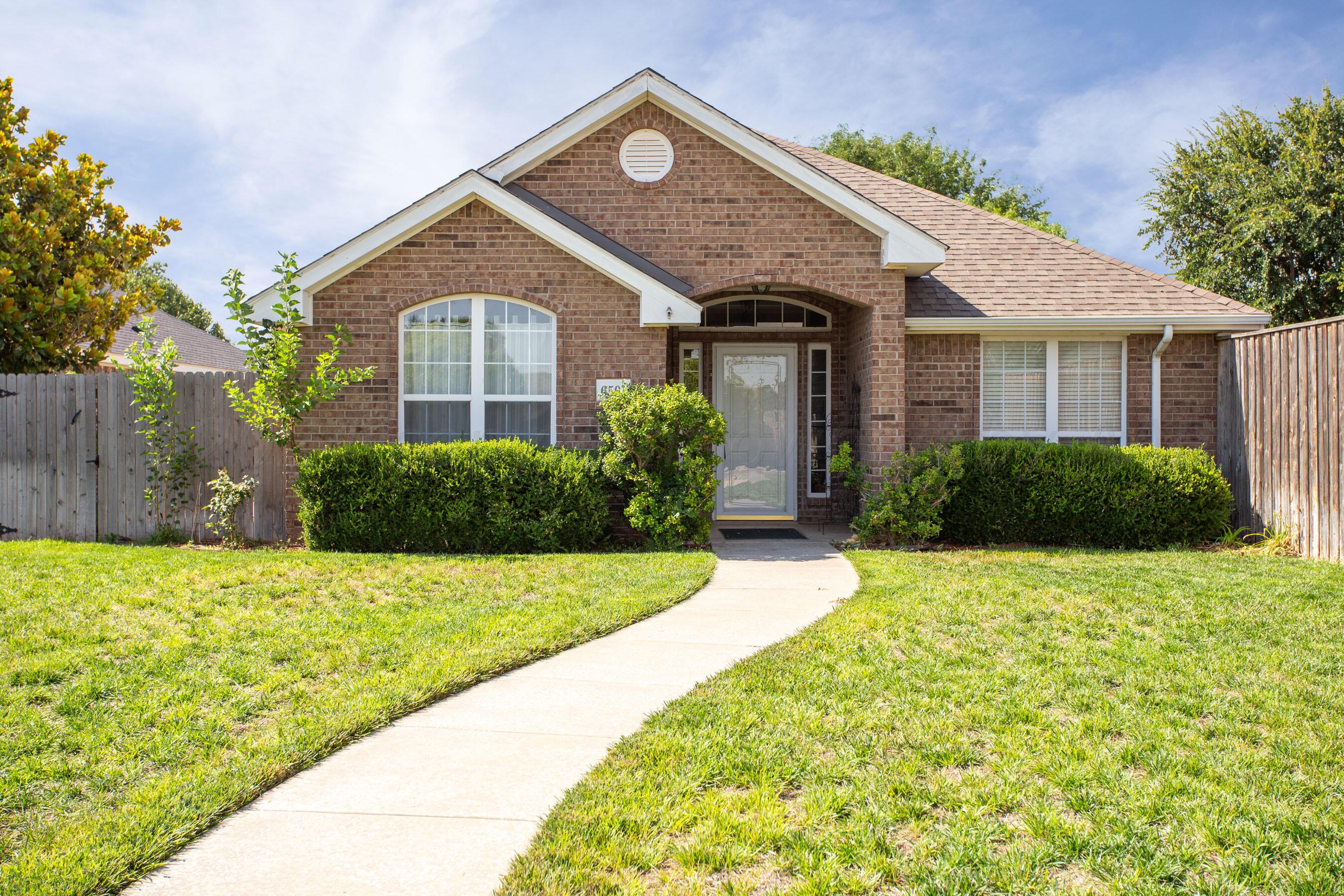 6501 Academy Drive Amarillo, TX 79119 - Photo 2 of 22 a front view of a house with a yard