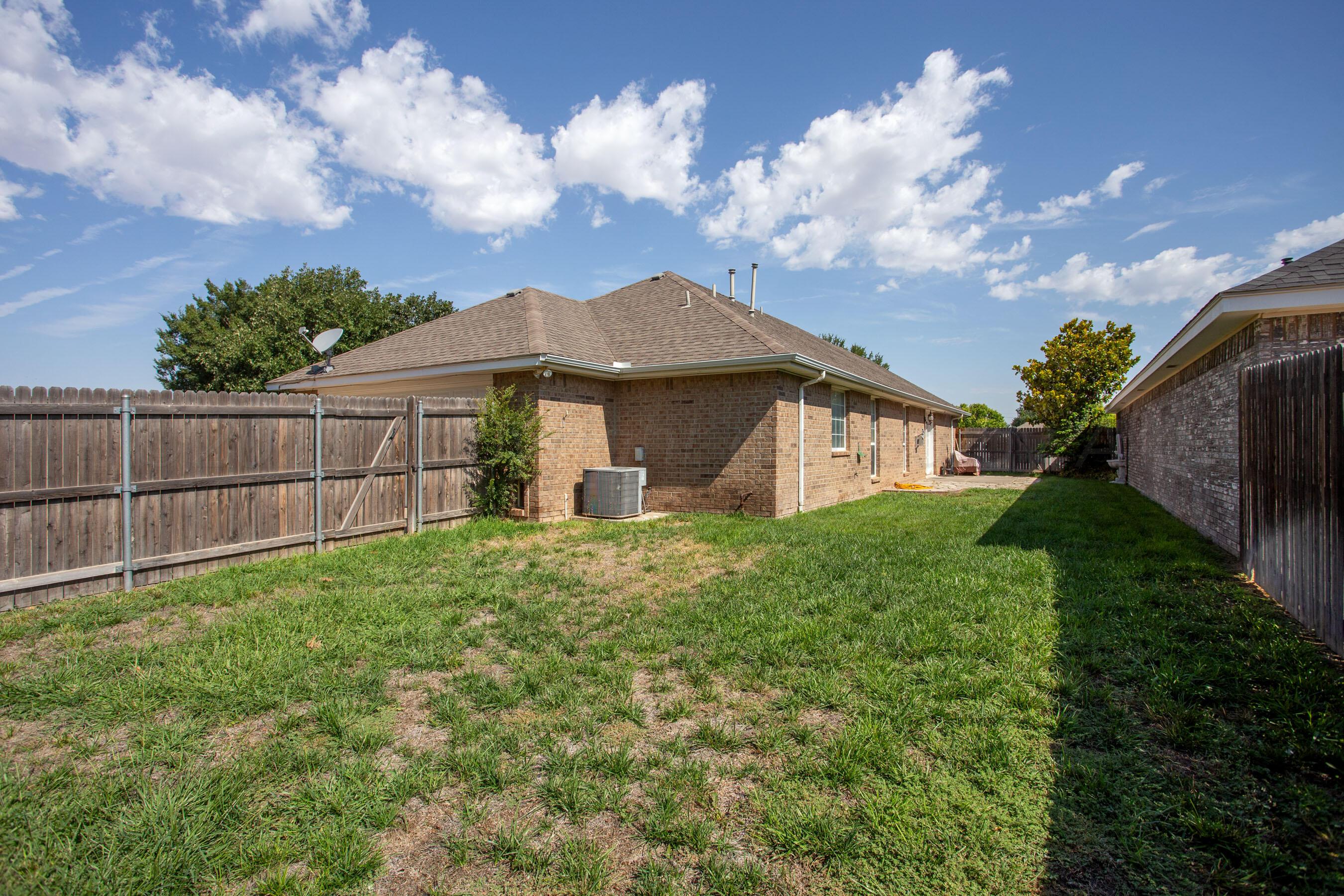 6501 Academy Drive Amarillo, TX 79119 - Photo 22 of 22 a view of a house with a big yard plants and large tree