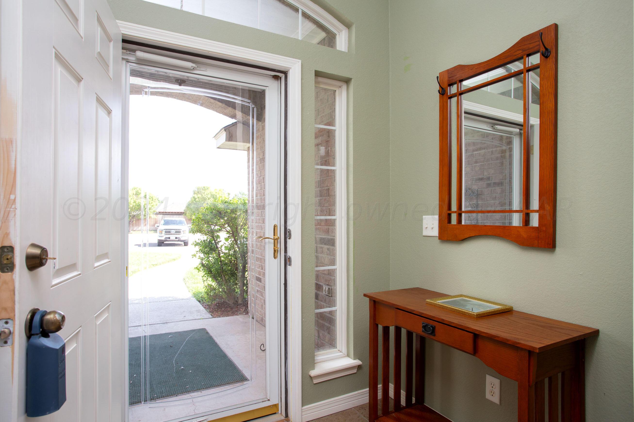 6501 Academy Drive Amarillo, TX 79119 - Photo 3 of 22 a room that has a window and a wooden floor