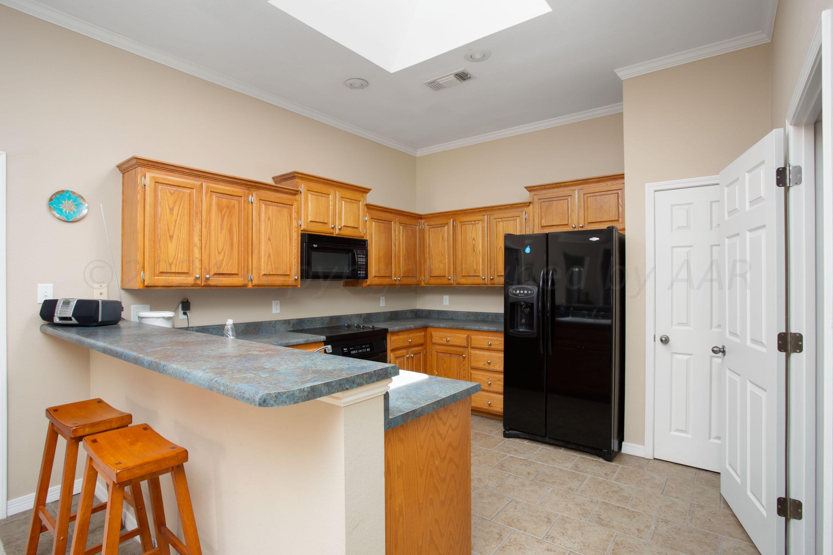 6501 Academy Drive Amarillo, TX 79119 - Photo 7 of 22 a kitchen with stainless steel appliances granite countertop a refrigerator and a sink