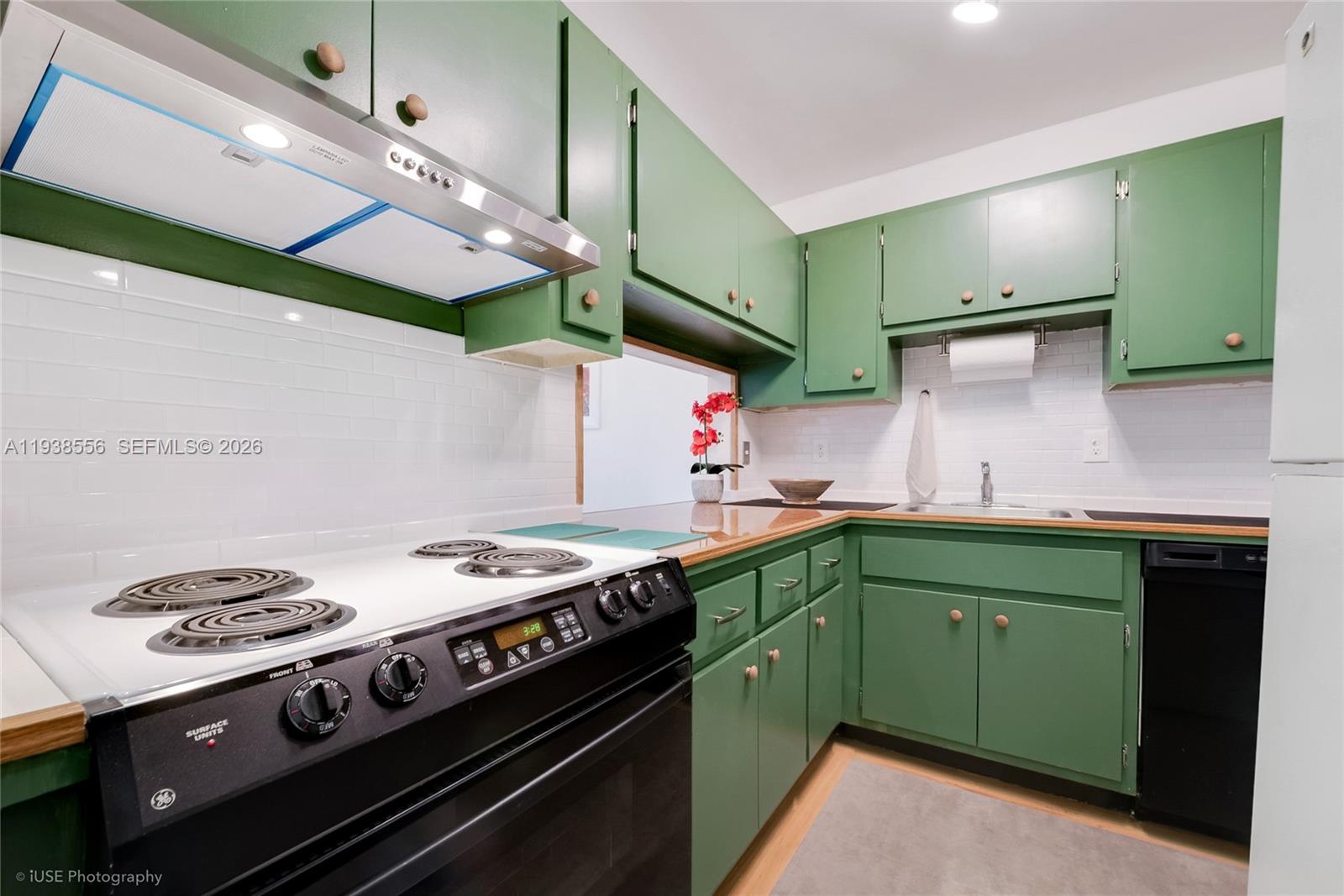 7403 Southwest 82nd Street, Unit 210N Miami, FL 33143 - Photo 7 of 14 a kitchen with a stove and a sink