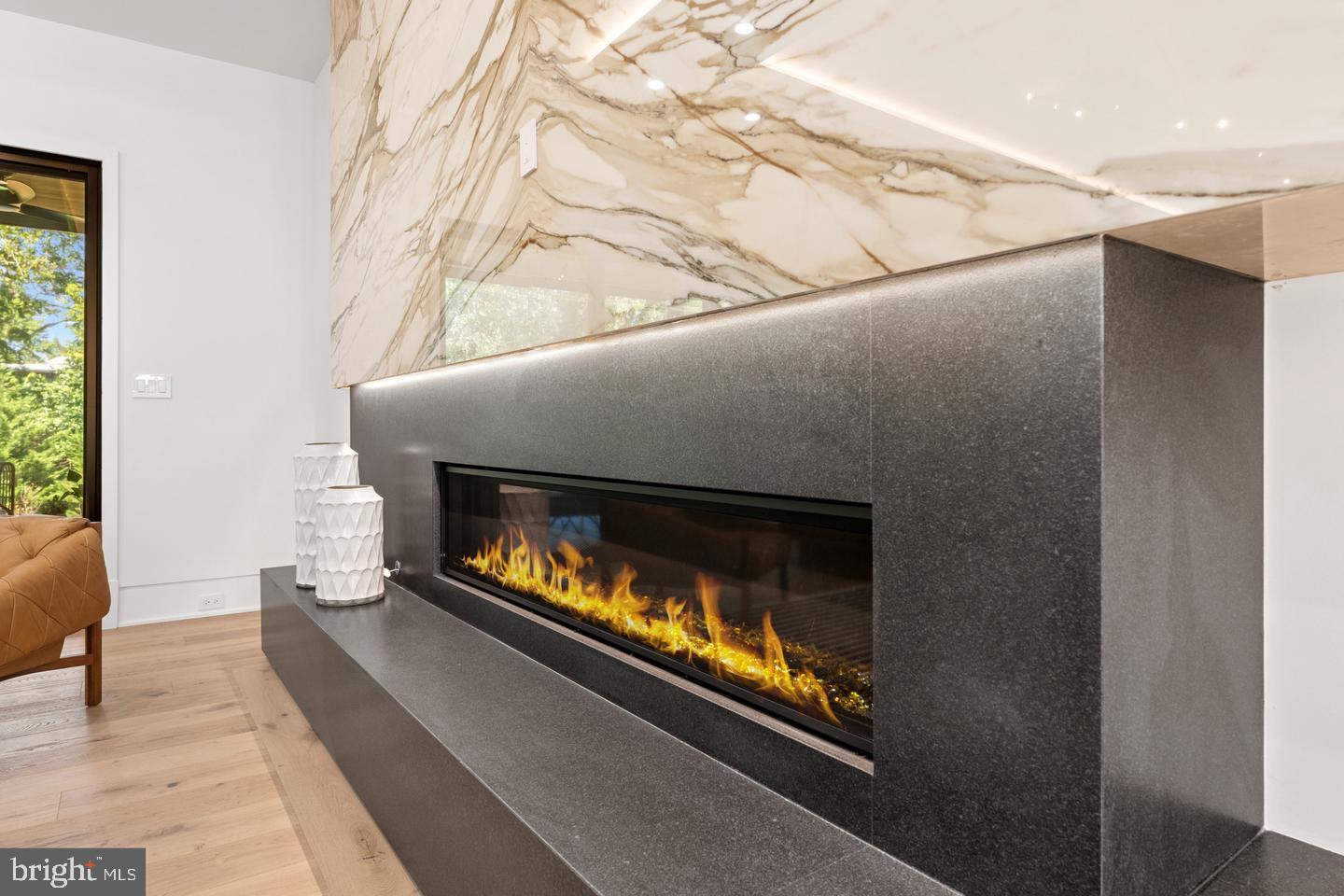 1138 Basil Road McLean, VA 22101 - Photo 10 of 24 Sleek fireplace with elegant marble backdrop.