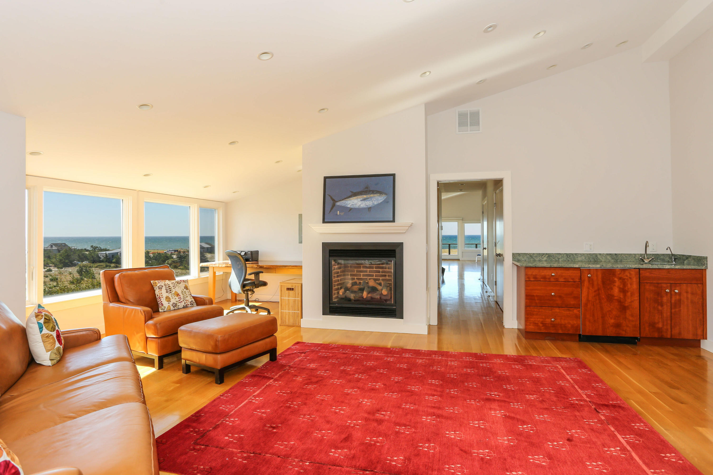 20 Great Hills Road Truro, MA 02666 - Photo 22 of 29 a living room with furniture a fireplace and a floor to ceiling window