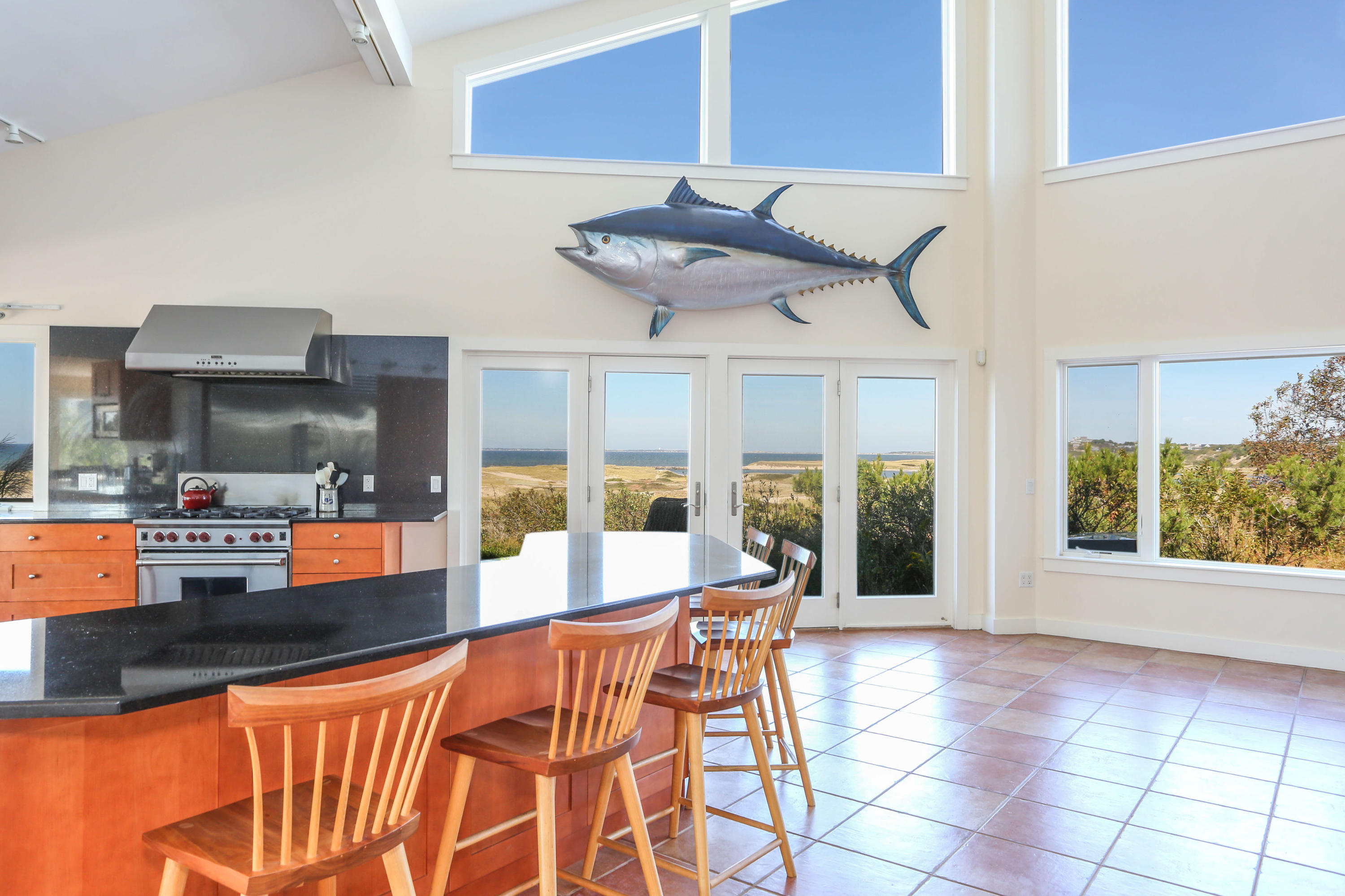 20 Great Hills Road Truro, MA 02666 - Photo 9 of 29 a dining hall with stainless steel appliances kitchen island granite countertop a table and chairs in it