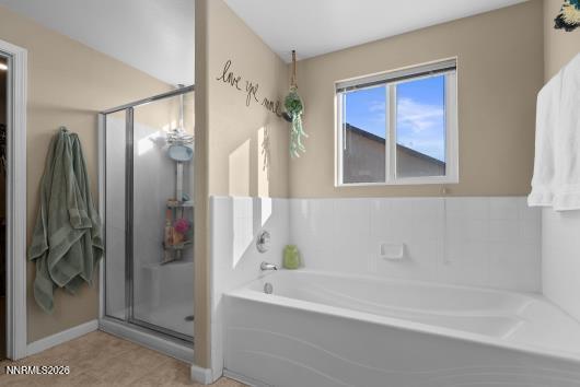 552 Spur Court Fernley, NV 89408 - Photo 27 of 46 a bathroom with a bathtub and a shower