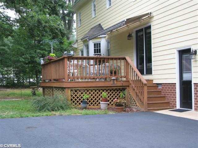 13231 Singer Road Midlothian, VA 23112 - Photo 2 of 12 Exterior Back - Back of house sports a deck perfect for relaxing with an electric awning, overlooking a large back yard and next to the attached 2 car garage,.