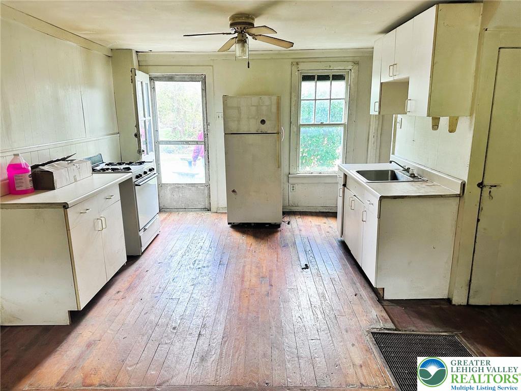 3783 Huckleberry Road Allentown, PA 18104 - Photo 11 of 27 a kitchen with sink a refrigerator and wooden floor