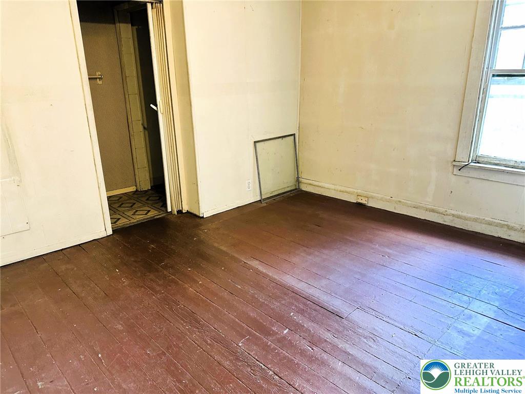 3783 Huckleberry Road Allentown, PA 18104 - Photo 14 of 27 an empty room with wooden floor and windows