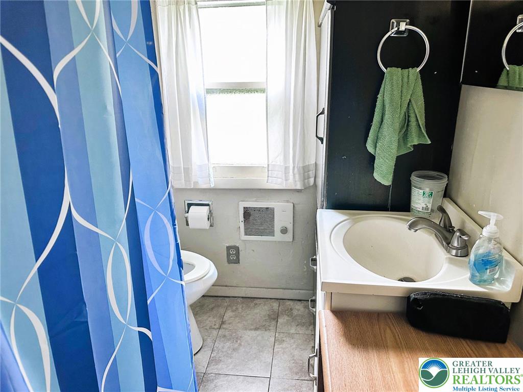 3783 Huckleberry Road Allentown, PA 18104 - Photo 6 of 27 a bathroom with a sink and mirror with toilet