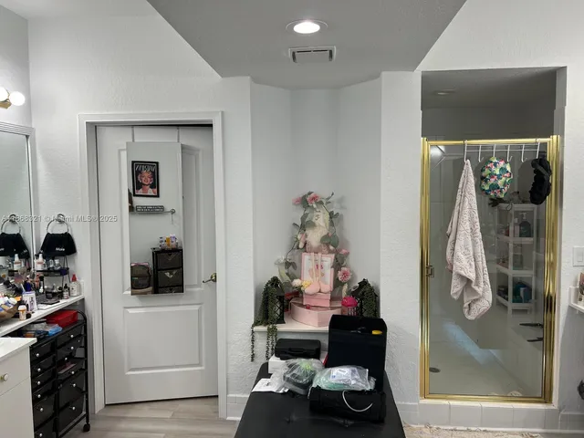 a view of walk in closet with clothes and shoes