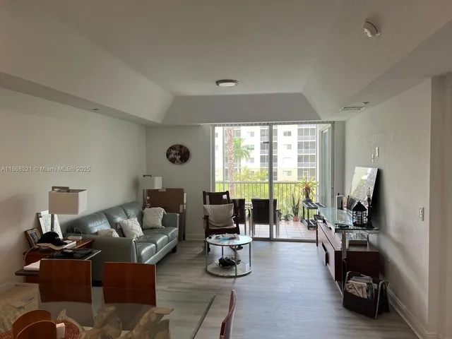 a living room filled with furniture and a potted plant