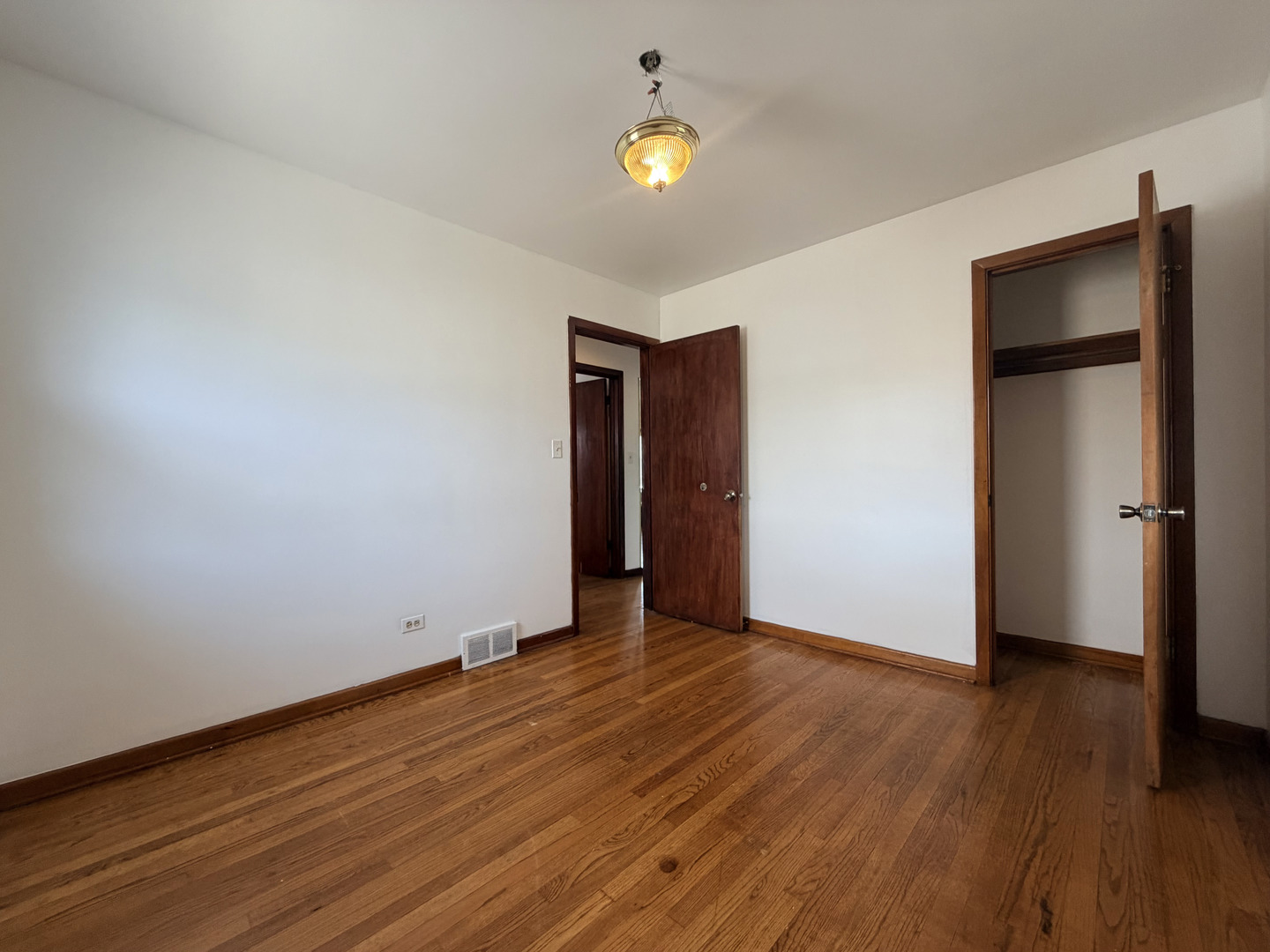 128 North York Road Bensenville, IL 60106 - Photo 15 of 39 a view of an empty room with wooden floor and a ceiling fan