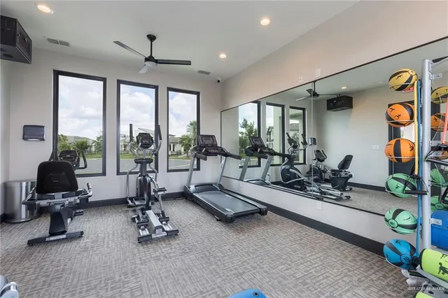 a living room with furniture windows and kitchen view