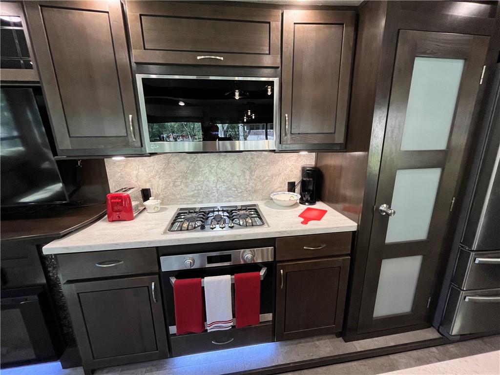 94 Bridge Loop Drive Cleveland, GA 30528 - Photo 20 of 79 a kitchen with stainless steel appliances granite countertop a stove and a refrigerator