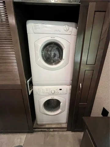 a view of a swimming pool with a patio and a yard