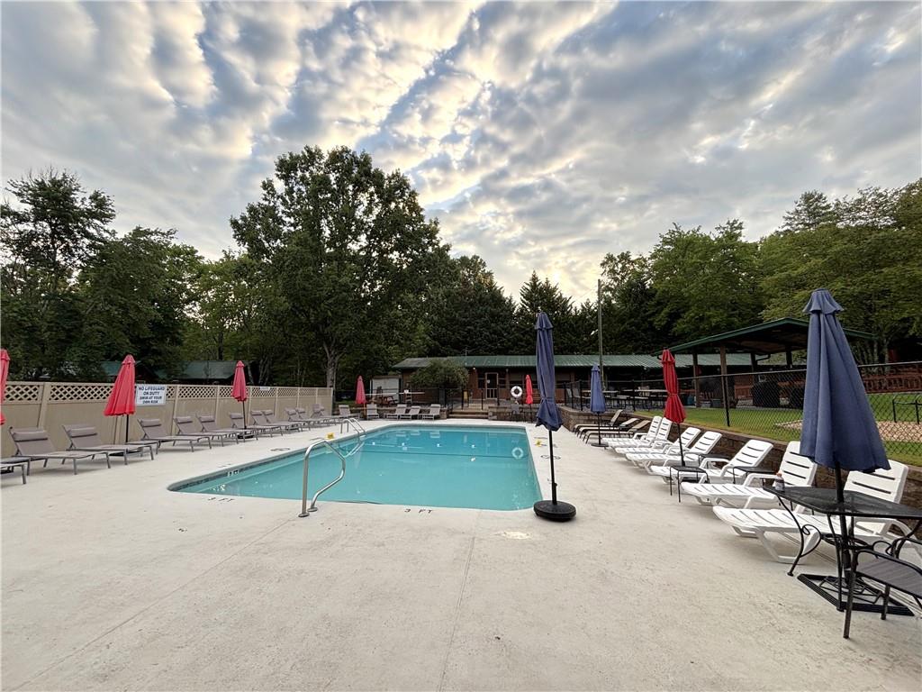 94 Bridge Loop Drive Cleveland, GA 30528 - Photo 62 of 79 a view of a swimming pool with a patio and a yard