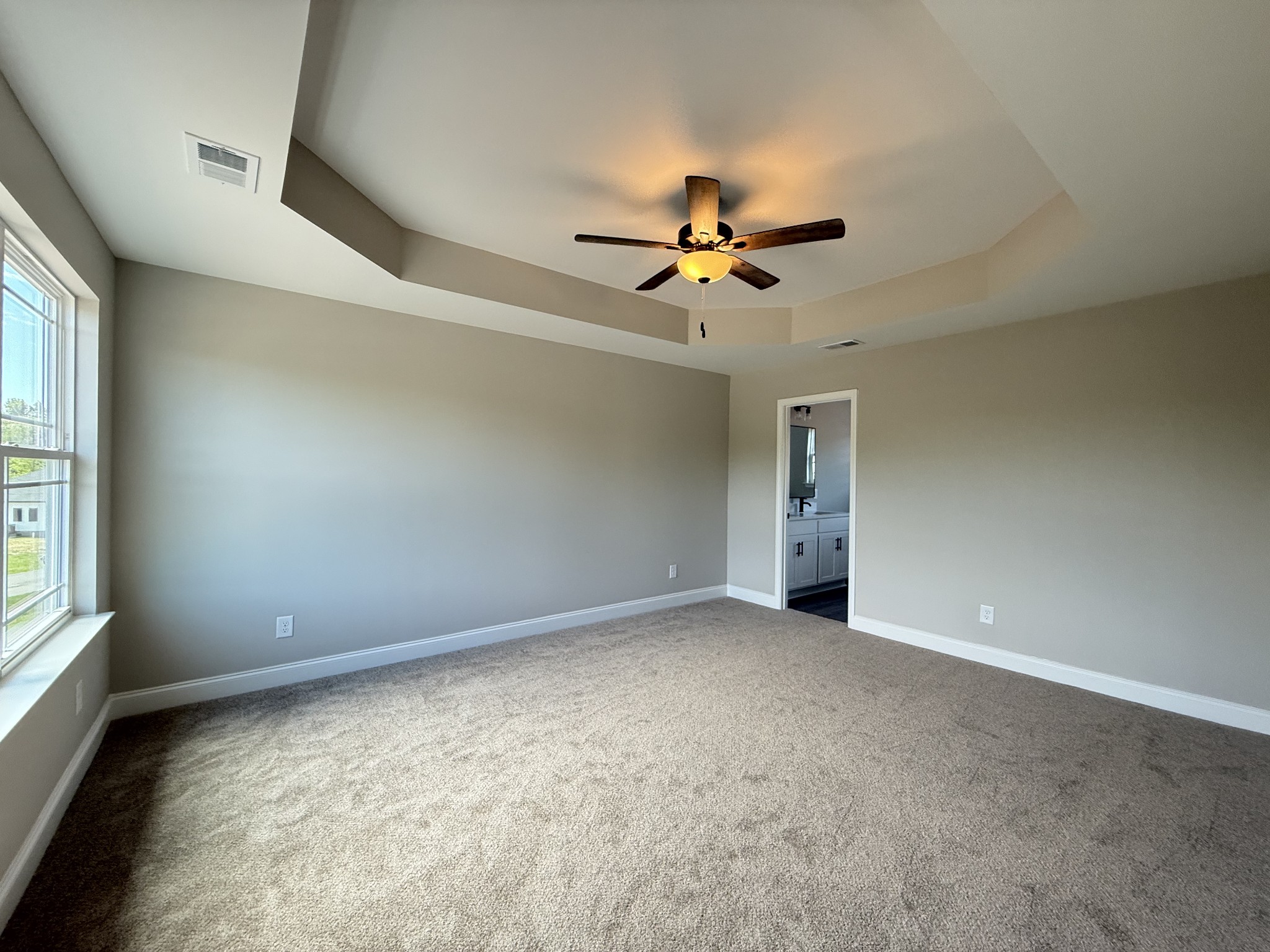 1020 Northside Drive Dickson, TN 37055 - Photo 4 of 10 an empty room with windows and fan