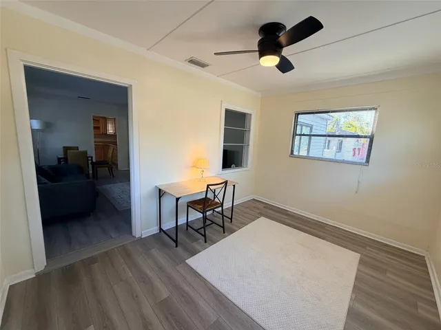 a living room with furniture and a ceiling fan
