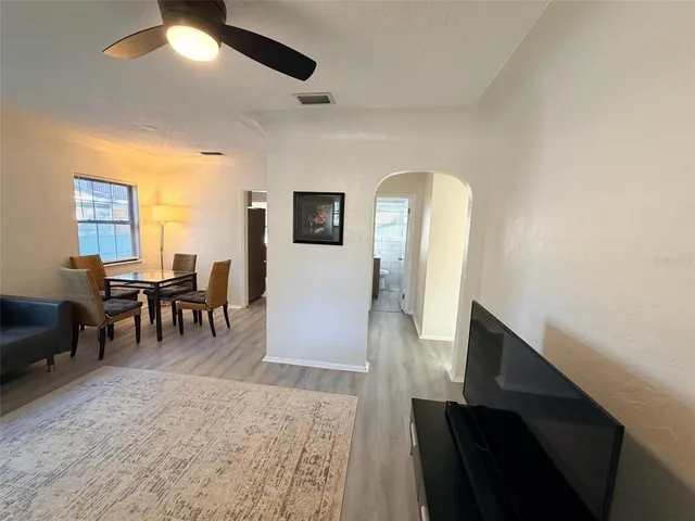 a dining room with furniture and a chandelier