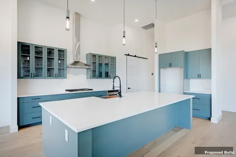 a kitchen with a stove a refrigerator a sink and chairs