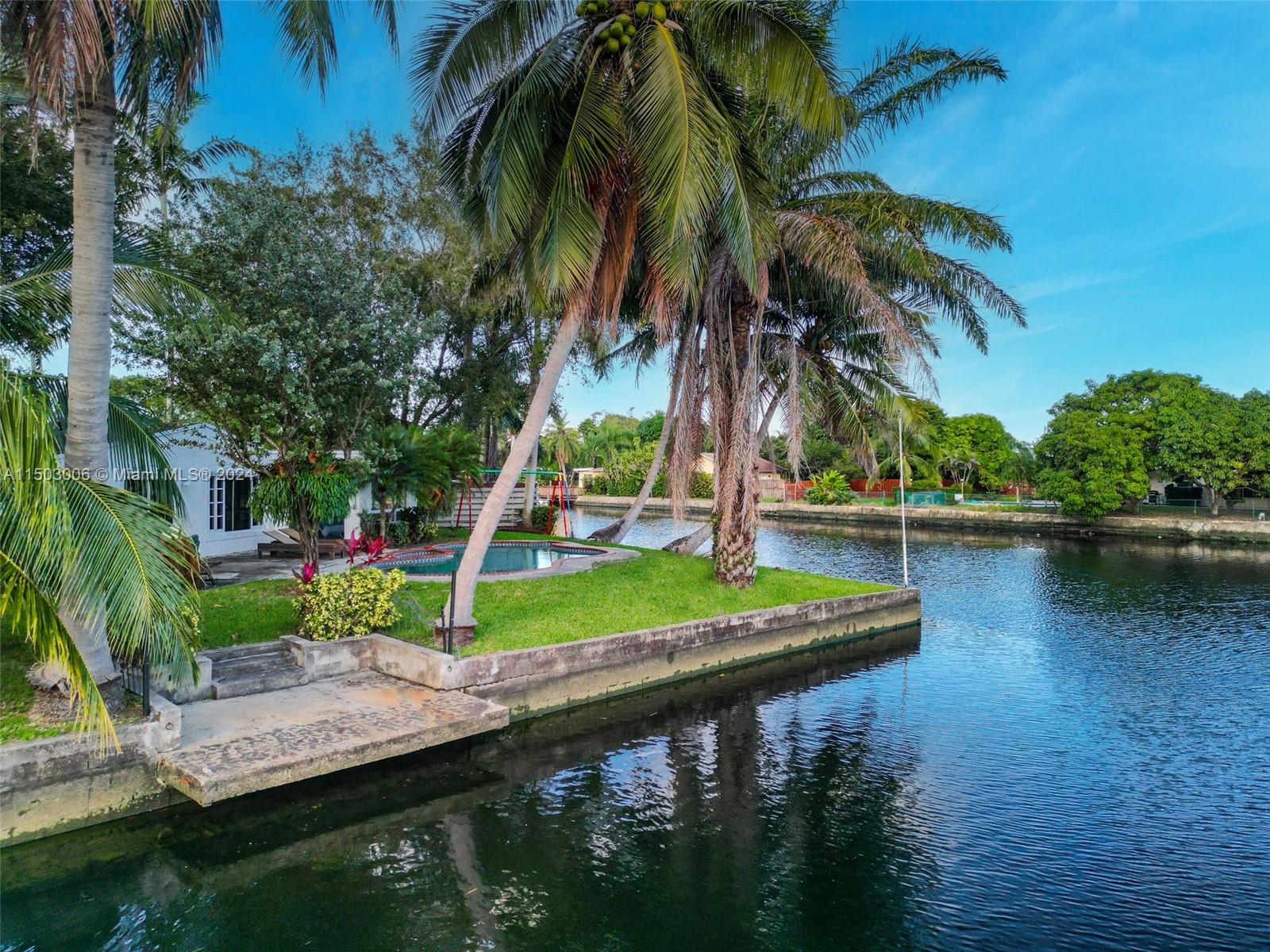 2702 Scott Street Hollywood, FL 33020 - Photo 1 of 42 a view of a wooden deck with a lake view