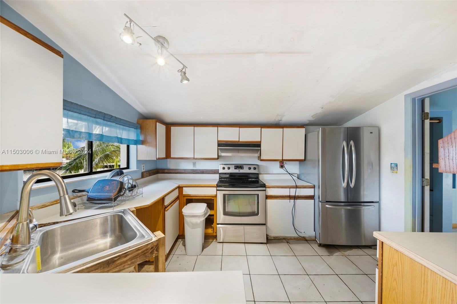 2702 Scott Street Hollywood, FL 33020 - Photo 27 of 42 a kitchen with stainless steel appliances granite countertop a sink refrigerator and cabinets