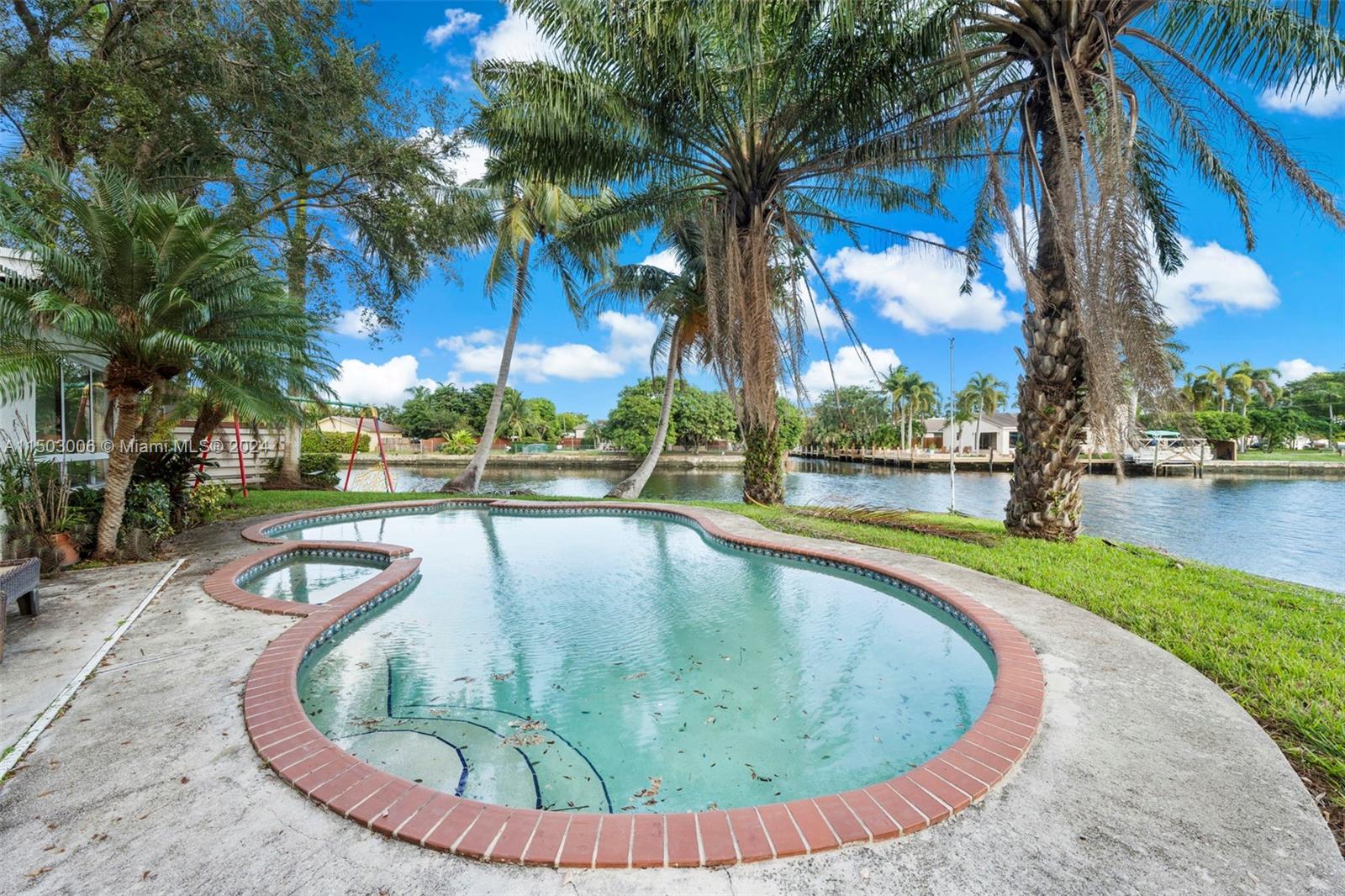 2702 Scott Street Hollywood, FL 33020 - Photo 35 of 42 a view of a swimming pool with a garden