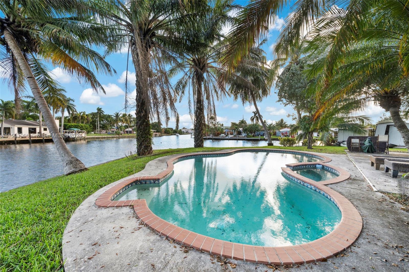 2702 Scott Street Hollywood, FL 33020 - Photo 39 of 42 a view of swimming pool with a garden and sitting area