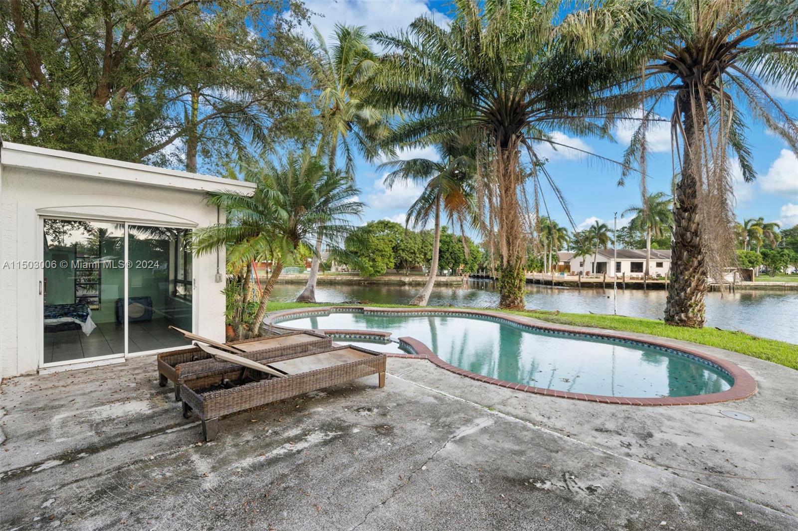 2702 Scott Street Hollywood, FL 33020 - Photo 41 of 42 a swimming pool with outdoor seating and yard