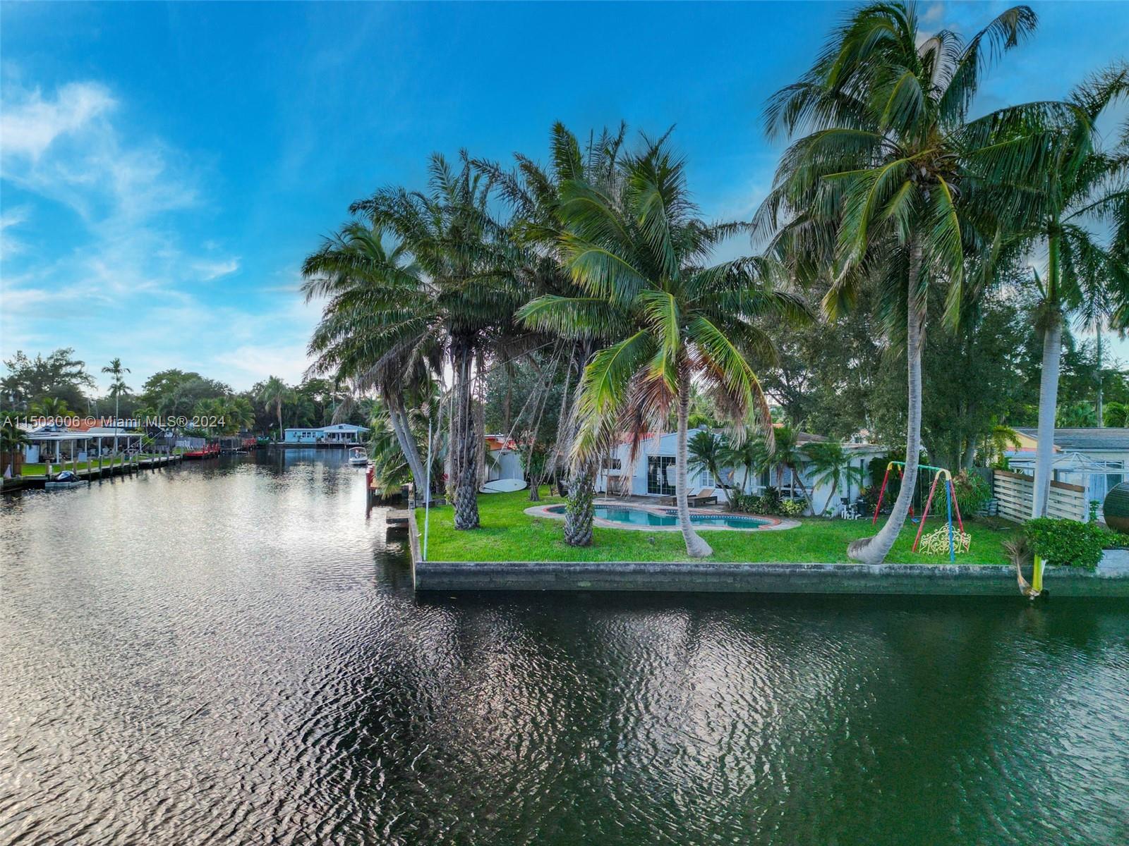 2702 Scott Street Hollywood, FL 33020 - Photo 7 of 42 a view of a lake with boats and palm trees