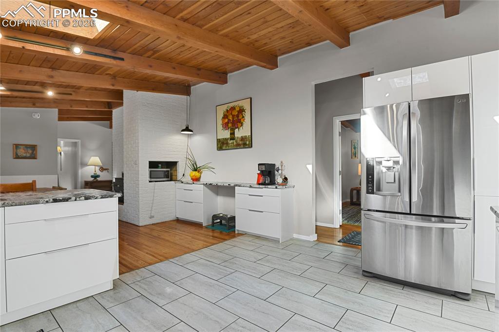 7015 McFerran Road Colorado Springs, CO 80908 - Photo 13 of 50 a kitchen with white cabinets and stainless steel appliances