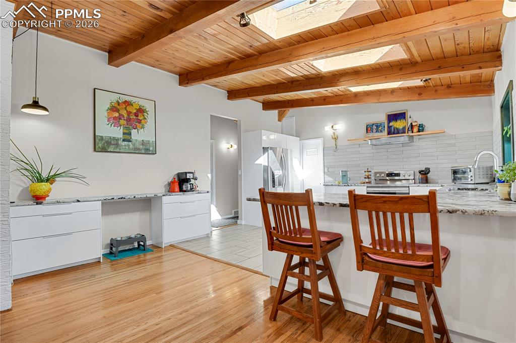 7015 McFerran Road Colorado Springs, CO 80908 - Photo 16 of 50 a workspace with furniture and wooden floor