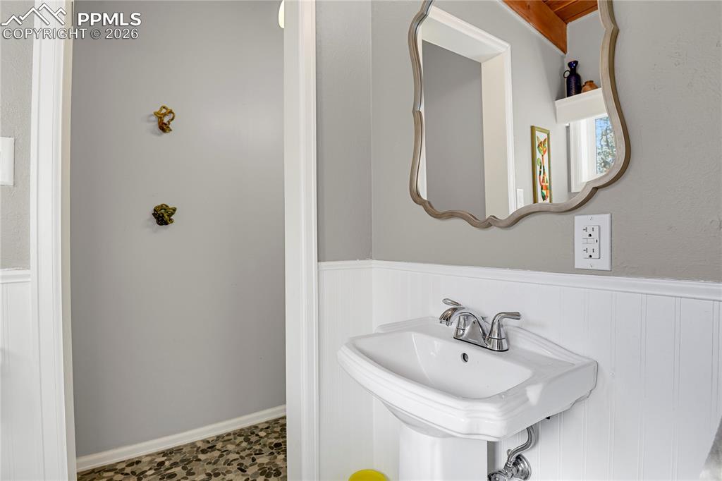 7015 McFerran Road Colorado Springs, CO 80908 - Photo 25 of 50 a bathroom with a sink and a mirror