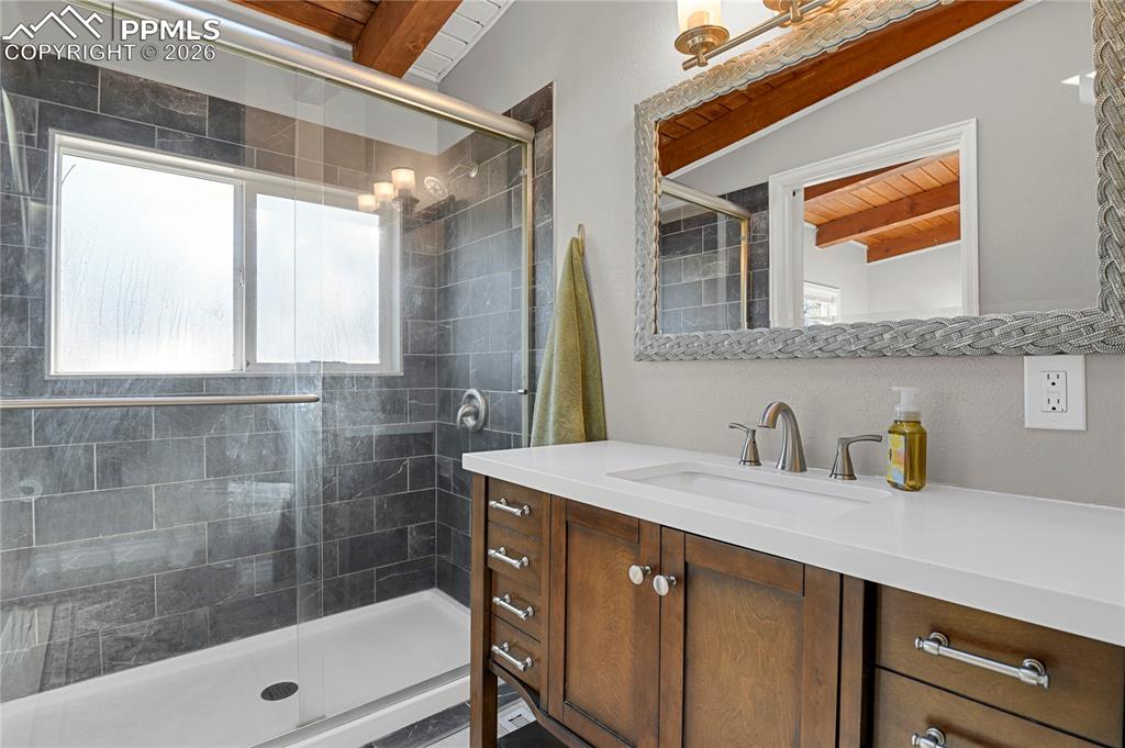 7015 McFerran Road Colorado Springs, CO 80908 - Photo 28 of 50 a bathroom with a sink and a mirror