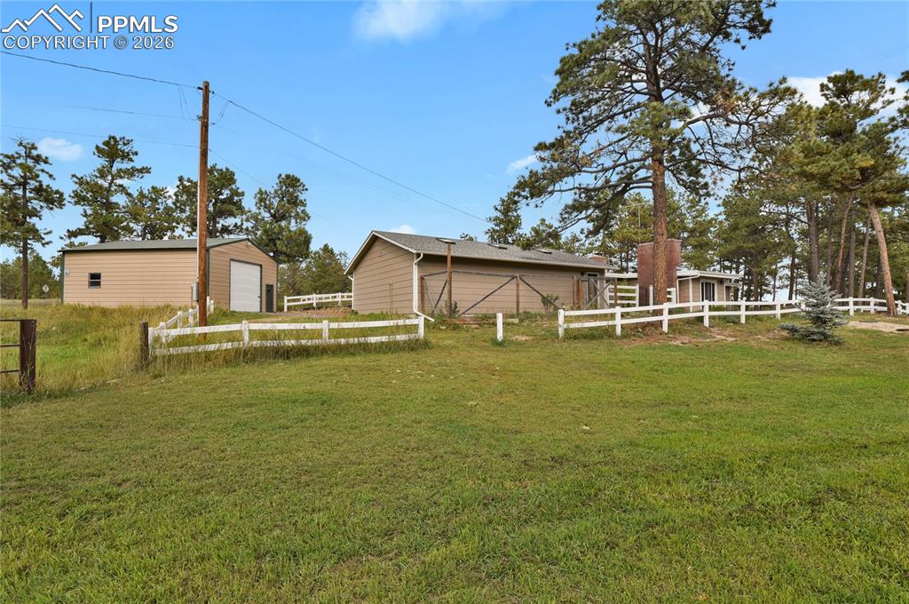 7015 McFerran Road Colorado Springs, CO 80908 - Photo 48 of 50 a front view of house with yard and trees