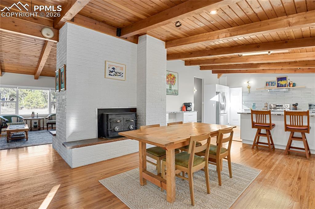 7015 McFerran Road Colorado Springs, CO 80908 - Photo 8 of 50 a view of a dining room with furniture window and wooden floor