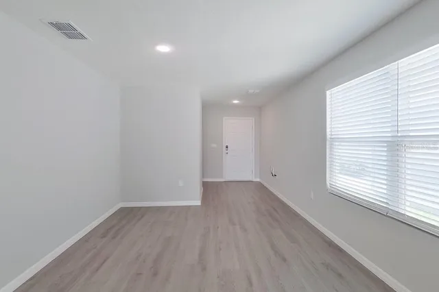 wooden floor in an empty room with a window