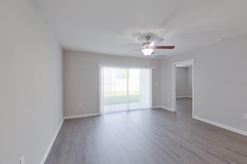 8731 Southwest 44th Court Ocala, FL 34476 - Photo 7 of 20 wooden floor in an empty room with a window