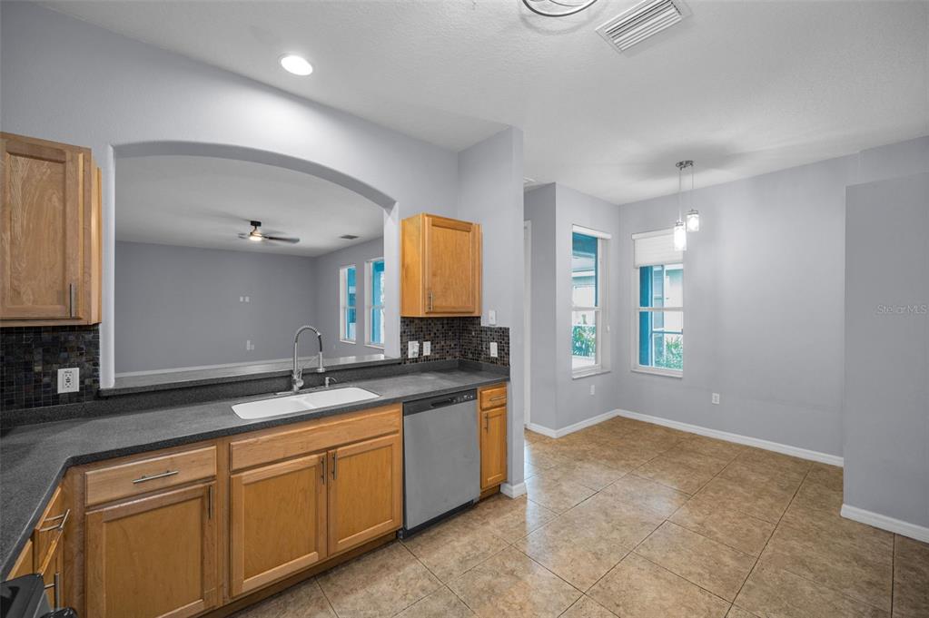 10125 Palladio Drive New Port Richey, FL 34655 - Photo 12 of 97 a spacious bathroom with a granite countertop sink a mirror and a
