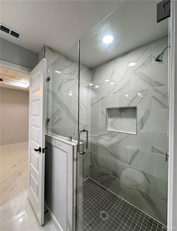 1604 Shadow Creek, Unit 1 Weslaco, TX 78596 - Photo 12 of 19 a bathroom with a glass shower door and a sink