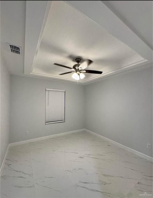 1604 Shadow Creek, Unit 1 Weslaco, TX 78596 - Photo 13 of 19 an empty room with a ceiling fan and a window