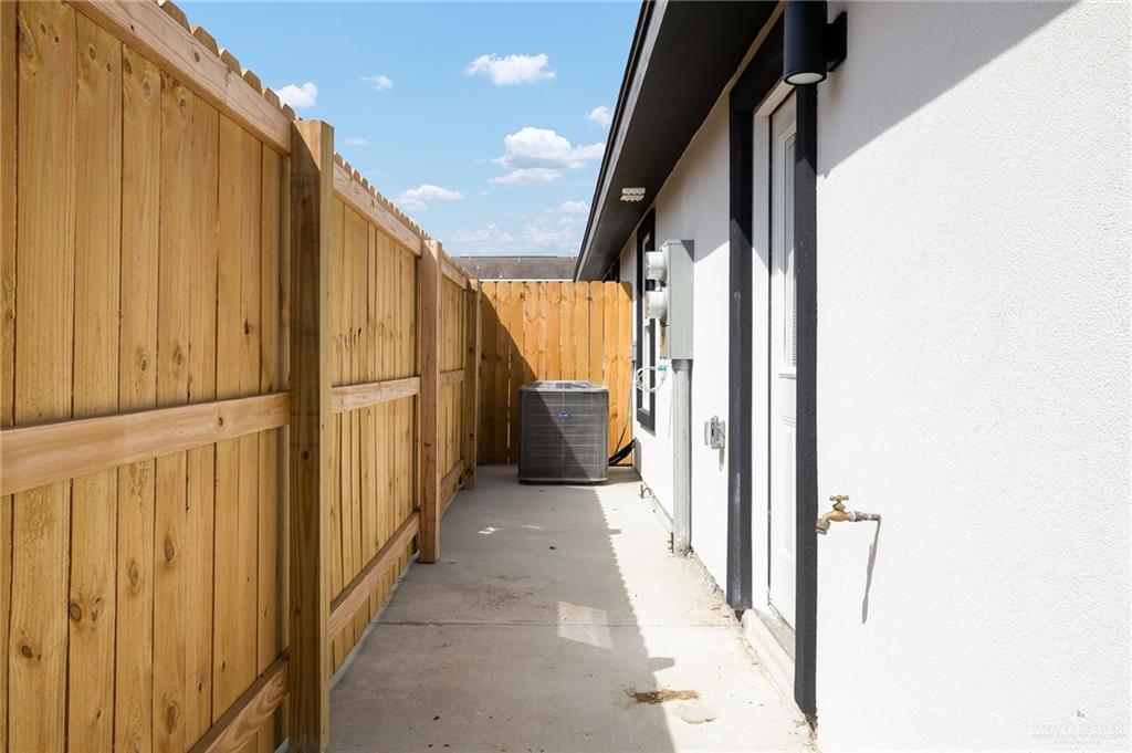 1604 Shadow Creek, Unit 1 Weslaco, TX 78596 - Photo 16 of 19 a view of a hallway with wooden cabinets and stairs