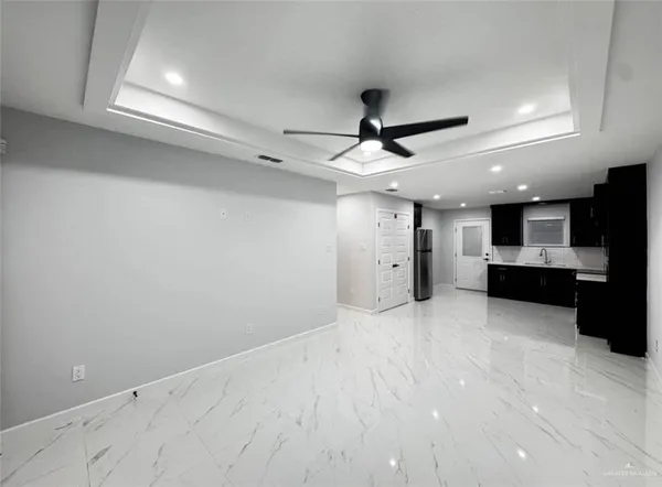 a view of a kitchen with a sink and stainless steel appliances