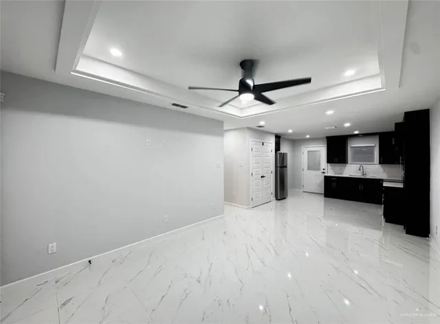 a view of a kitchen with a sink and stainless steel appliances
