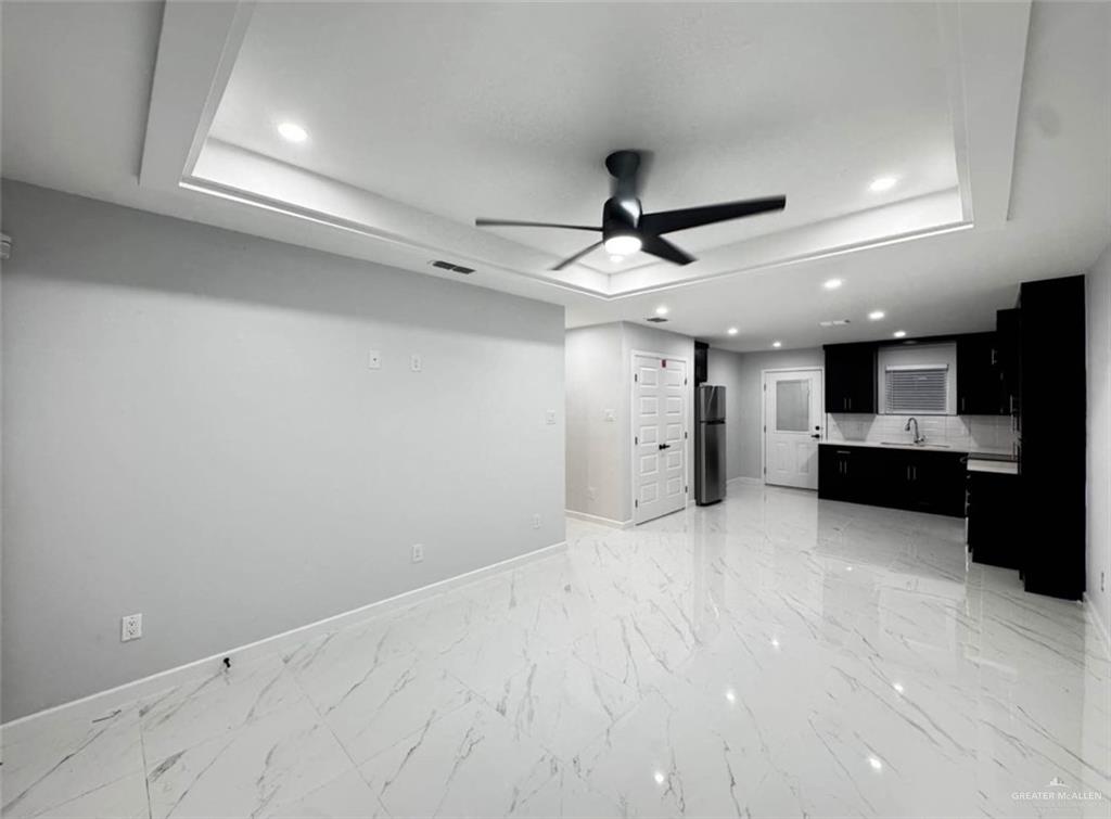 1604 Shadow Creek, Unit 1 Weslaco, TX 78596 - Photo 5 of 19 a view of a kitchen with a sink and stainless steel appliances